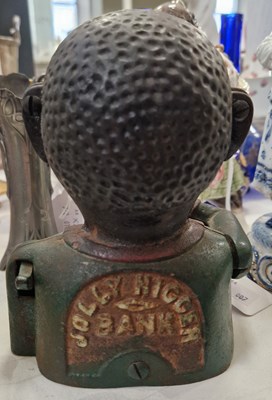 Lot 335 - A cast metal figural jolly money bank.