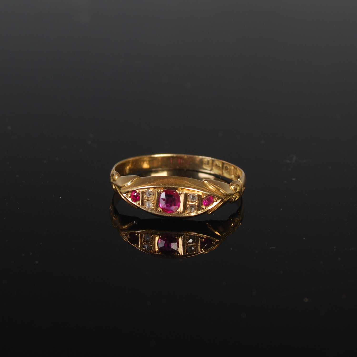Lot 30 - An 18ct gold ruby and diamond chip ring, size '...
