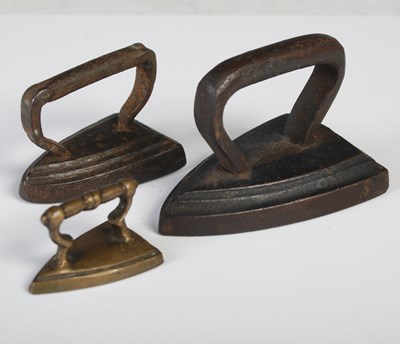 Lot 95 - Three miniature models of flat irons, the...