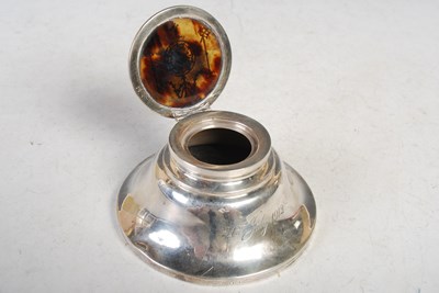 Lot 149 - A London silver circular inkwell, the hinged...