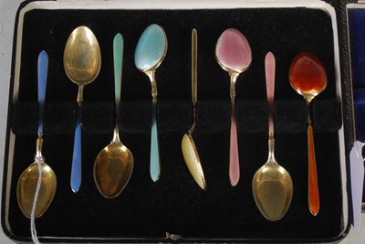 Lot 163 - A cased set of six silver gilt and coloured...