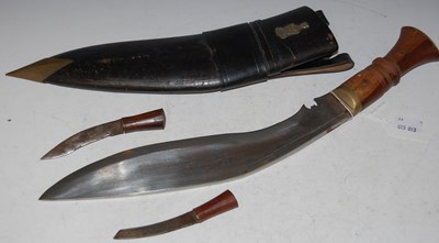 Lot 90 - A leather cased kukri knife in leather...